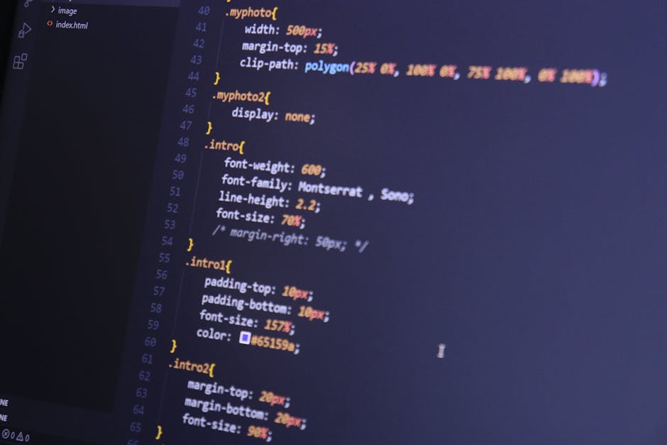 A computer screen displaying a dark-themed code editor with lines of CSS code in various colors, including yellow, pink, and purple, formatted with indentation and brackets. The code appears to define